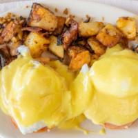 Eggs Benedict · 2 poached eggs on top of grilled canadian bacon and toasted english muffin covered in hollon...