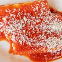 Stuffed Shells · Four stuffed shells topped with sauce. Served with bread and butter