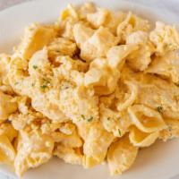 Baked Mac And Cheese · 4 cheese blend mixed with pasta and baked with a Ritz cracker crumb. Served with bread and b...