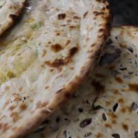 Naan · *Vegetarian* Fresh, warm bread baked inside our clay oven.