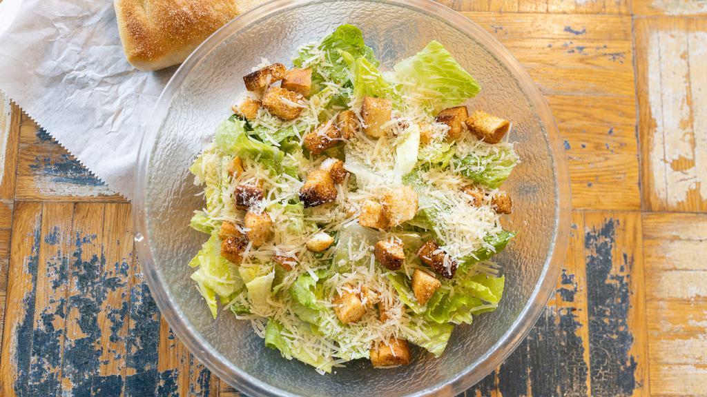 Caesar Salad · Crisp romaine lettuce with seasoned croutons, Parmigiano cheese & creamy caesar dressing.