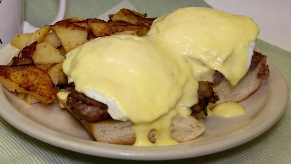 Dutch Benedict · Two extra large eggs basted with scrapple on an English muffin topped with hollandaise sauce and a side of homefries