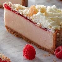 Raspberry Donut Cheesecake · Creamy raspberry and donut-flavored cheesecake sits on a graham cracker crust, topped with r...