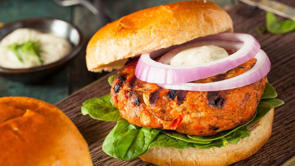 Chopped Salmon Brioche Burger · Delicious Chopped Salmon Burger freshly prepared and cooked to perfection. Served on a Brioche bun with a side of fries.