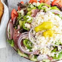 Greek Salad With Garlic Bread · Large Greek salad loaded with fresh mushrooms, onions, bell peppers, tomatoes, cucumbers, ol...
