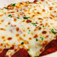 Chicken Parmigiana · Breaded boneless chicken breast baked in our brick oven with marinara sauce topped with mozz...