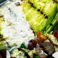 Wedge Salad · An iceberg wedge over spinach. Crispy pancetta, gorgonzola cheese, grapes, spiced candied wa...