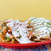 Loaded Nachos · Topped with melted cheese, beans, guacamole, pico de gallo and sour cream. Add lengua(tongue...