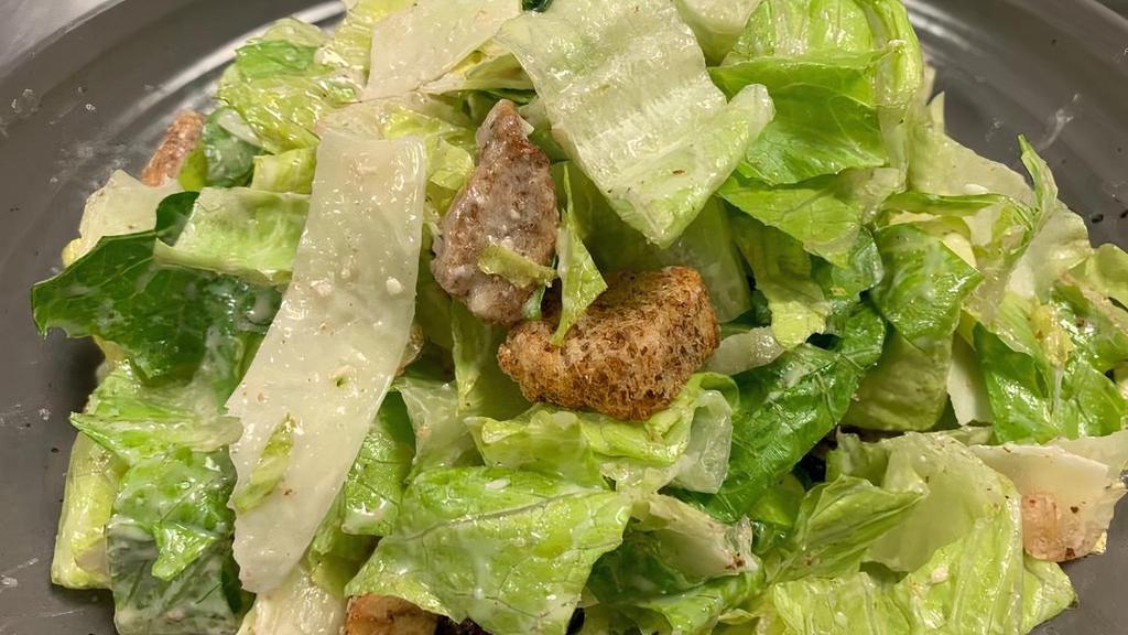 Caesar · Crisp Romaine lettuce with croutons, shaved Parmesan cheese, and Turner's Caesar dressing.  No anchovies.