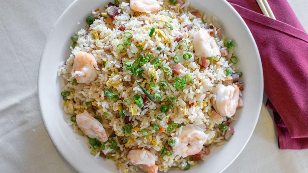 Young Chow Fried Rice · Combination of shrimp pork ham and vegetables stir-fried with rice.