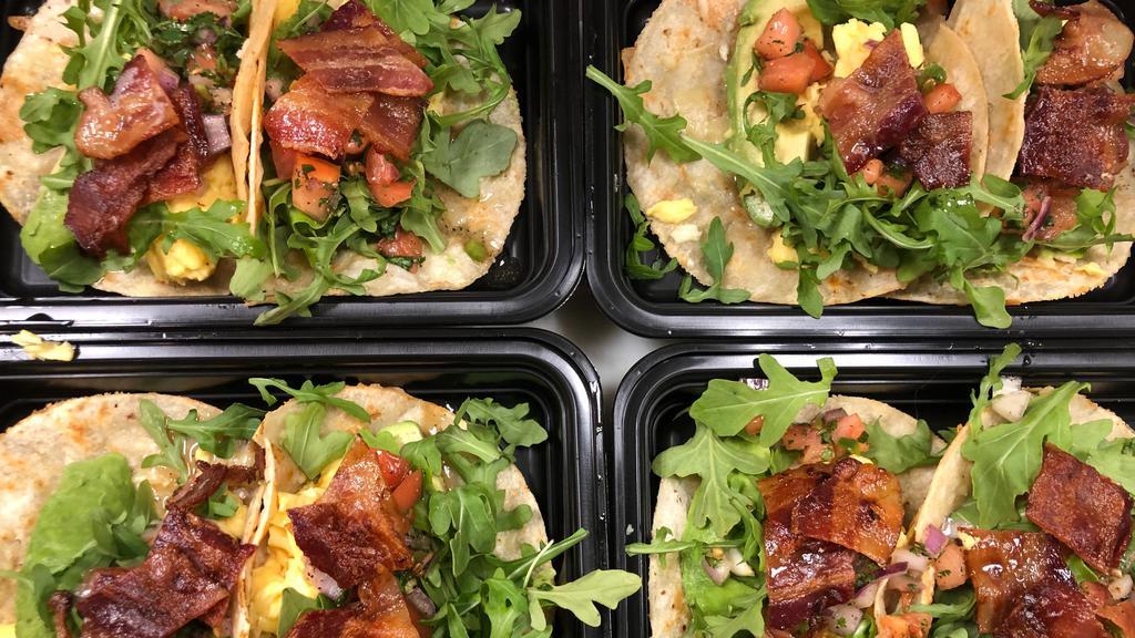 Breakfast Tacos · Two soft corn Tortillas filled with scrambled Eggs, Cheddar Cheese, Bacon, our house-made Pico de Gallo, Avocado and Arugula. Allergens: Dairy and Egg,