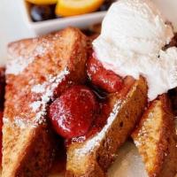 Strawberry Just The Toast · Two thick cut slices of house made bread dipped in egg custard and grilled.  Layered with va...