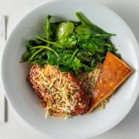 Chicken Parm Bowl · Our crispy chicken parmesan served over quinoa with sautéed garlic spinach.  Topped with our...