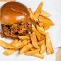 Pulled Pork Sandwich · Slow cooked pork served with BBQ sauce on a roll with fries.