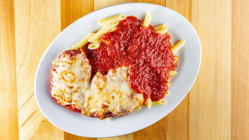 Chicken Parm · Generous portion of breaded chicken cutlet topped with marinara sauce and Mozzarella cheese. Served with pasta and a salad.
