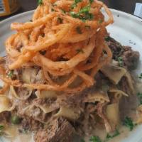 Short Rib Stroganoff · Beef short rib, shallots, and rich beef broth with sour cream and English peas over papparde...