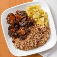 Oxtails · Beef oxtail served with two sides.
