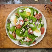 Spinach Salad · Spinach, feta, bacon, onion, olives, and two hard-boiled eggs tossed with house dressing.
