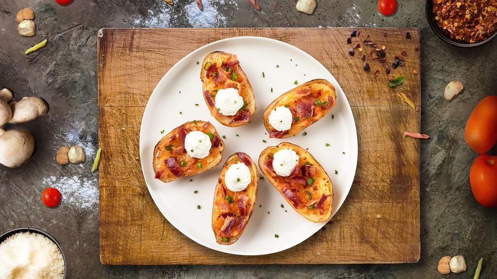 Potato Skins With Bacon & Cheddar  · Baked potato skins filled with cheddar cheese, bacon, scallions, and topped with sour cream.