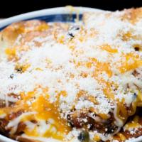 Bodega Nachos · From the oven.  chilaquiles, three cheese blend, spicy salsa, jalpenos & black beans.
