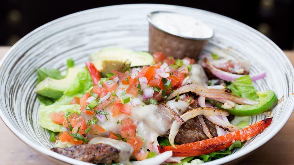 Churasca Steak · Grilled rib - eye, pepper jack, pico de gallo, avocados, grilled peppers & onions over romaine.