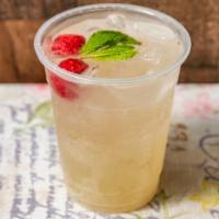 Raspberry Spritz Lemonade · An elegant sparkling lemonade topped with a mint sprig.