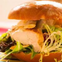 Classic Chicken Salad · Classic chunky chicken salad sits on top of chewy rustic bread with baby greens, sliced toma...