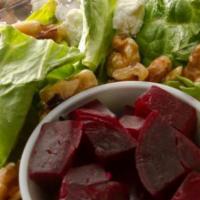 Beet & Goat Cheese Salad · A bed of mixed greens is served with goat cheese, cranberries, roasted walnuts and beets. Be...