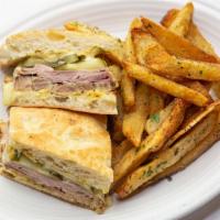 Cuban · House roasted pork, sliced ham, Swiss cheese, pickles and mustard. Served with hand-cut Fren...