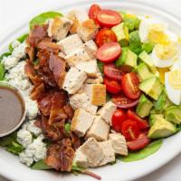 Classic Cobb · Rows of chopped chicken breast, blue cheese, tomatoes, hard boiled egg, bacon and avocado.