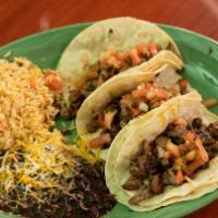 Carne Asada Tacos · Steak a la Plancha (diced steak) seared on a hot iron skillet topped with homemade salsa.