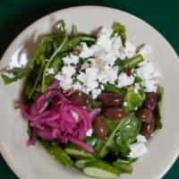 Greek Feta Salad · Classic Greek with greens, pickled onions, olives, cucumber, and dondi feta.