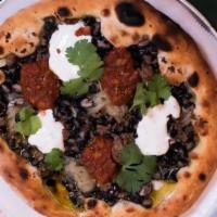 Comet Taco Pizza · Organic ground beef, black beans, crema, spicy salsa, cilantro and lime.