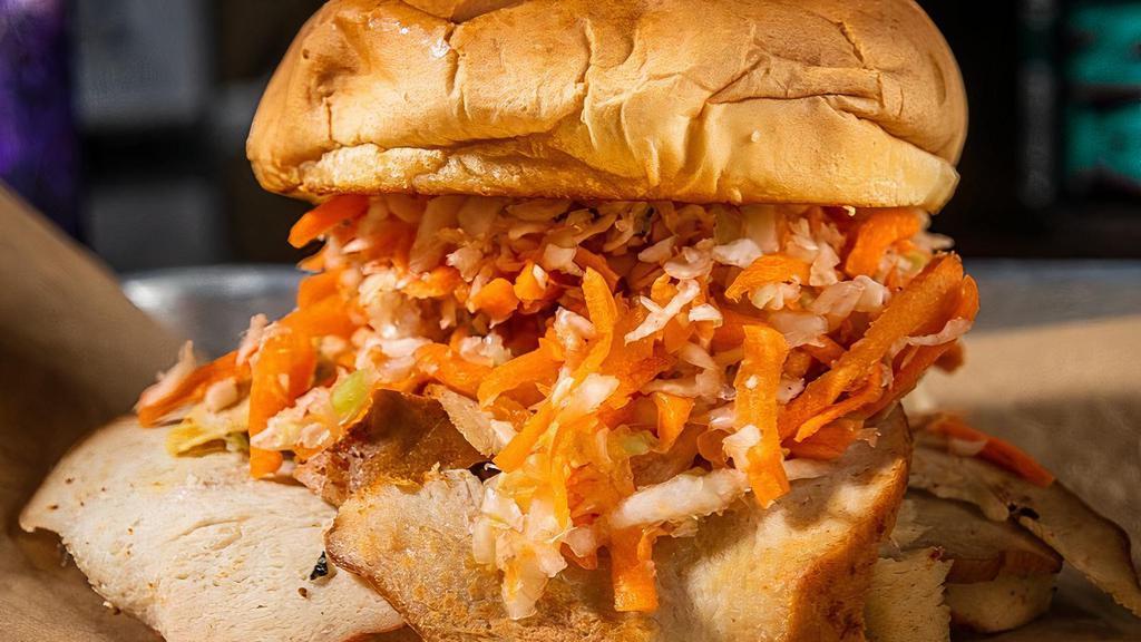 Vegan Turkey Sandwich · Vegan. Our house-smoked vegan turkey is smoked on a vegan bun with slaw and our mellow mustard sauce. Served with pickles, raw onion, cornbread, choice of one side, and choice of one sauce.
