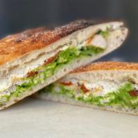 Pesto Schiacciata · Roasted chicken, roasted red peppers, spinach pesto, and provolone. Served with a small giar...
