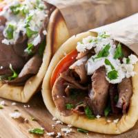 Gyro · Spicy. A delicious blend of beef and lamb with spices, thinly sliced and served on warm pita...