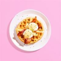 Waffle Benedict · A fluffy Belgian waffle topped with poached eggs, crispy bacon, creamy Hollandaise, and chop...