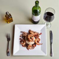 Grilled Shrimp Risotto · grilled shrimp served with sauteed spinach risotto topped with tomato, scallion olive oil le...