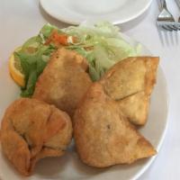 Vegetable Samosa · Indian pastries stuffed with lightly spiced potatoes and peas and other vegetables.
