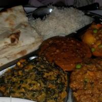 Indian Thali · An assortment of vegetarian dishes including mixed vegetable curry, saag paneer, bengan bhar...