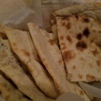 Garlic Naan · Light bread stuffed with fresh crushed garlic and coriander and baked in the tandoor.