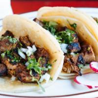 Tacos · Topped with onions and cilantro.