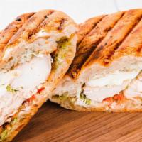 Chicken Pesto Panini · Grilled chicken, pesto sauce topped with hot red peppers, and melted Cheddar cheese.