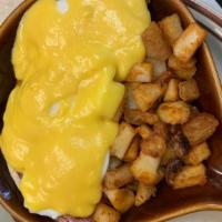 Eggs Benedict · Poached eggs with ham on English halves, topped with hollandaise sauce and panhandled potato...
