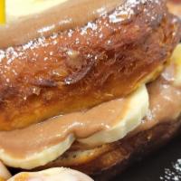 Nutella & Banana Stuffed Donut · Filled with fresh bananas and homemade Nutella whipped cream.  Topped with powdered sugar an...