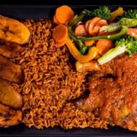 Jollof Rice · Jollof rice served the red stew with goat meat, beef, chicken, fresh fish or fried fish.