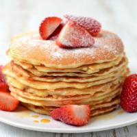 Strawberry Buttermilk
Pancakes · Three perfectly fluffy strawberry pancakes served with a side of butter and syrup.