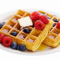 Blueberry Belgian Waffles · Crisp cake of batter baked in a waffle iron topped with fresh blueberries served with a side...