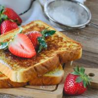 Strawberry French Toast · Sliced fresh bread soaked in eggs and milk, then fried topped with fresh strawberries served...