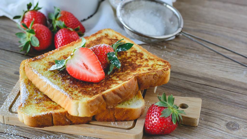 Strawberry French Toast · Sliced fresh bread soaked in eggs and milk, then fried topped with fresh strawberries served with a side of butter and syrup.